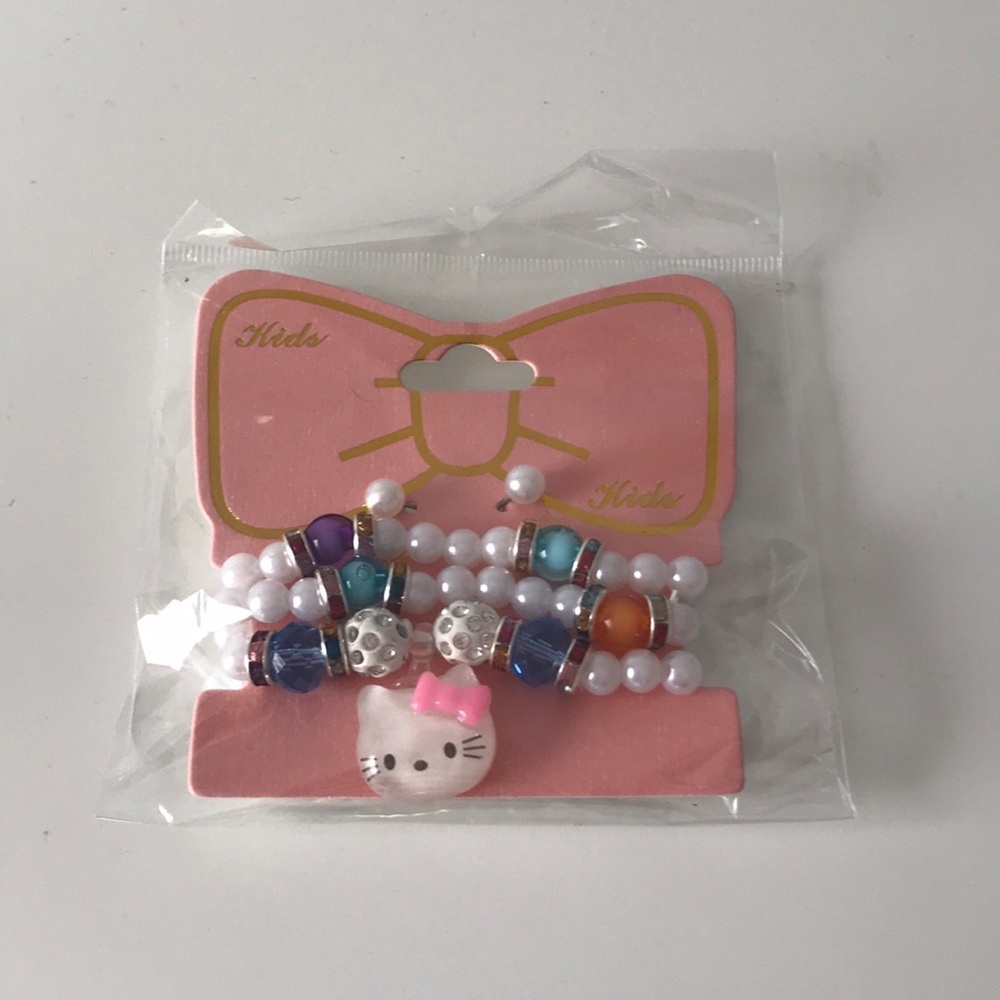 Hello Kitty bracelets and pearl earrings